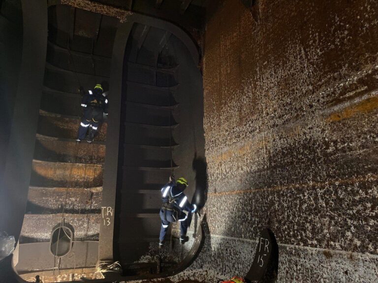 Rope access technicians inspecting internal tank structure in a confined space offshore